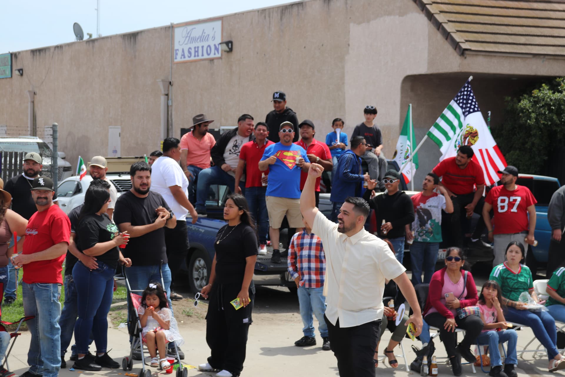 Juan Telles cheering with neighbors at a community parade