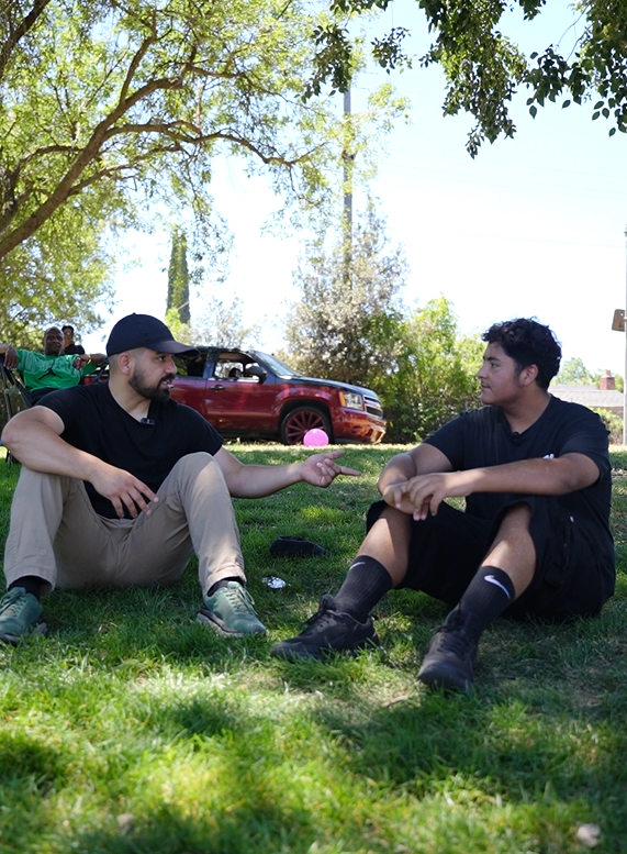 Juan having a one-on-one conversation with a young community member