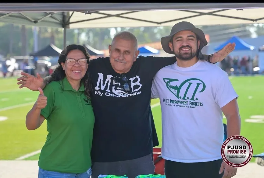 Juan engaging with community members at an outdoor event